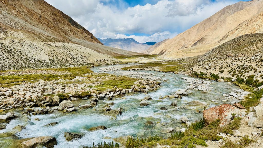 glacial stream, river, ice water, icy water, panaromic view, mountain, clouds, valley